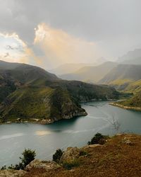 Scenic view of lake and mountains against sky