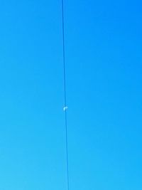 Low angle view of cables against clear blue sky