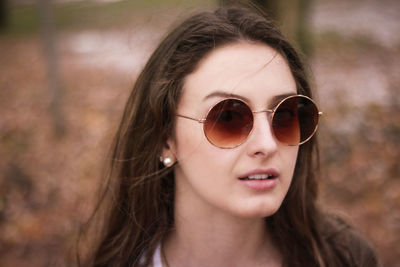 Close-up of portrait of beautiful young woman wearing sunglasses