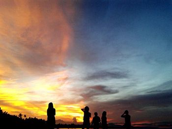 Silhouette of landscape against cloudy sky at sunset