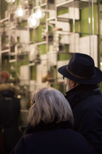 Rear view of couple sitting outdoors