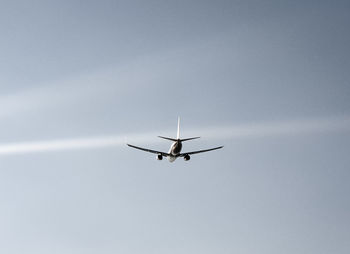 Low angle view of airplane flying in sky