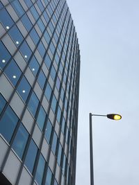 Low angle view of street light against building