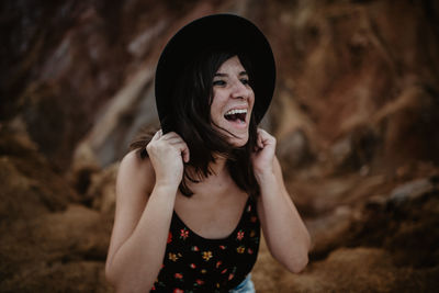 Portrait of young woman standing outdoors