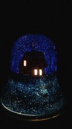 Close-up of illuminated blue light against black background