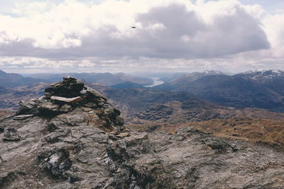 Scenic view of mountains against cloudy sky