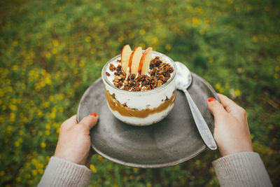 Close-up of hand holding coffee cup