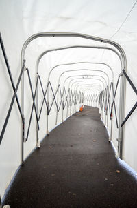 Empty road leading to built structure