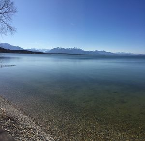 Scenic view of lake against clear blue sky