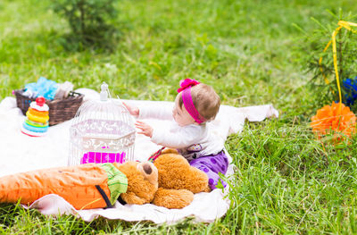 Rear view of girl with toy on field