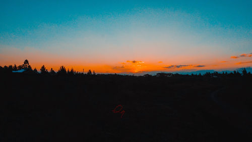 Scenic view of silhouette landscape against romantic sky at sunset