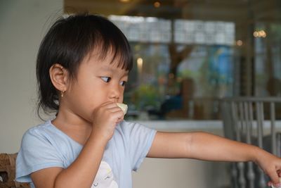 Close-up of cute girl eating at restaurant