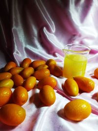 Fruits askumquat , inside glass jar, white background, night photography