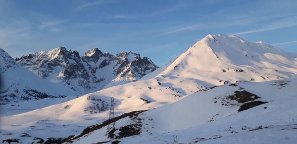 Scenic view of snow covered mountains against sky