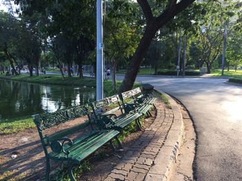 Empty bench by footpath in park