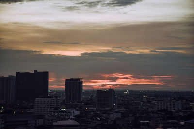 Modern buildings against sky during sunset