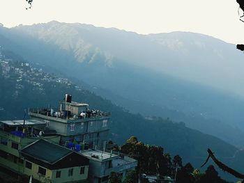 High angle view of buildings and mountains against sky