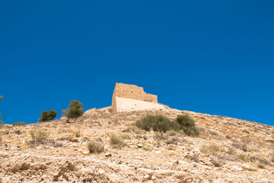 Low angle view of castle against clear blue sky