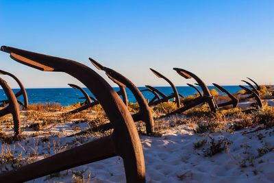 Scenic view of beach against clear blue sky during winter