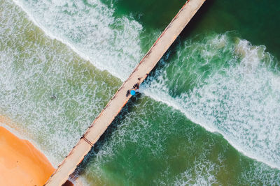 Directly above shot of people on pier over sea