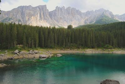 Scenic view of lake carezza by mountain