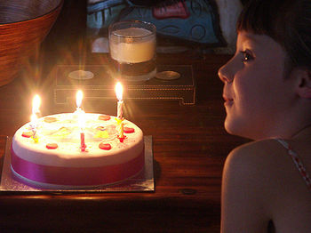 Close-up of illuminated candle in darkroom