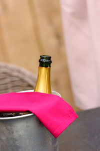 Iron winecooler without cork with a magenta serviette waiting for the guests to arrive 