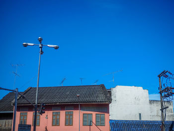 Low angle view of buildings against clear blue sky