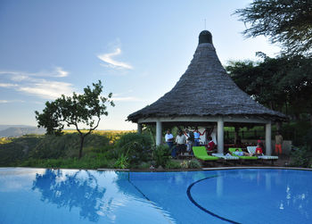 View of swimming pool by building against sky