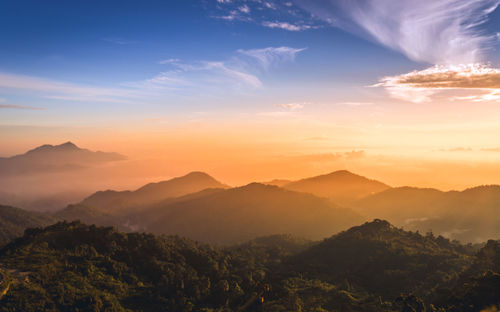 Scenic view of mountains against sky at sunset