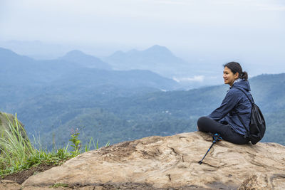 Woman resting on top of adam's peak close to ella in sri lanka