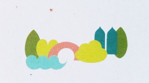 Close-up of multi colored paper over white background