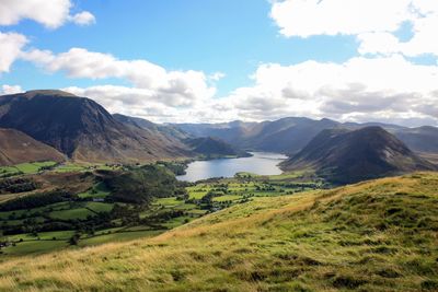 Crummock water lake amidst mountains against sky at cumbria
