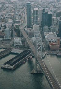 High angle view of bridge over river amidst buildings in city