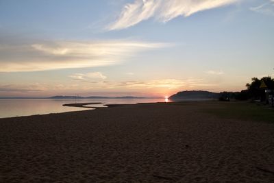 Scenic view of beach against sky during sunset