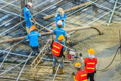 People working in shopping cart at construction site