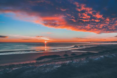 Scenic view of beach against sky during sunset