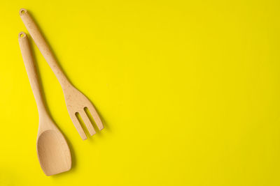 Directly above shot of yellow and knife on white background