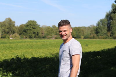 Portrait of young man standing on land