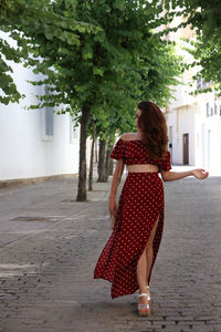 Young woman walking on street in city