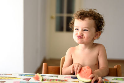 Cute girl eating watermelon at home