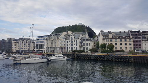 Boats in river with buildings in background