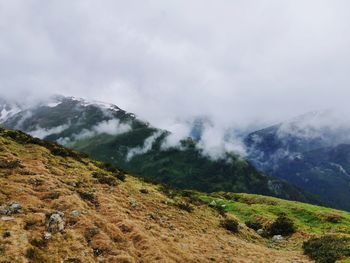 Scenic view of mountains against cloudy sky