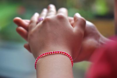 Cropped hand of woman holding hands outdoors