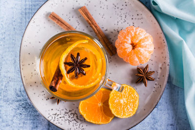 Mandarin tea with cinnamon and anise in a cup on the table. antioxidant diet. top view. closeup