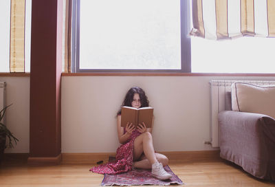 Woman sitting on chair at home