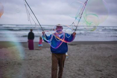 Man making bubbles at beach