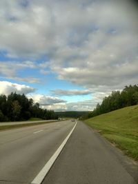 Empty road against cloudy sky