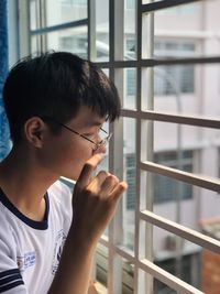 Boy looking through window