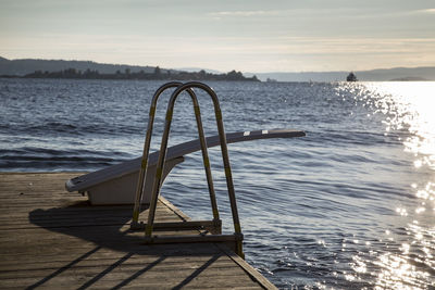 Diving platform on boardwalk by lake